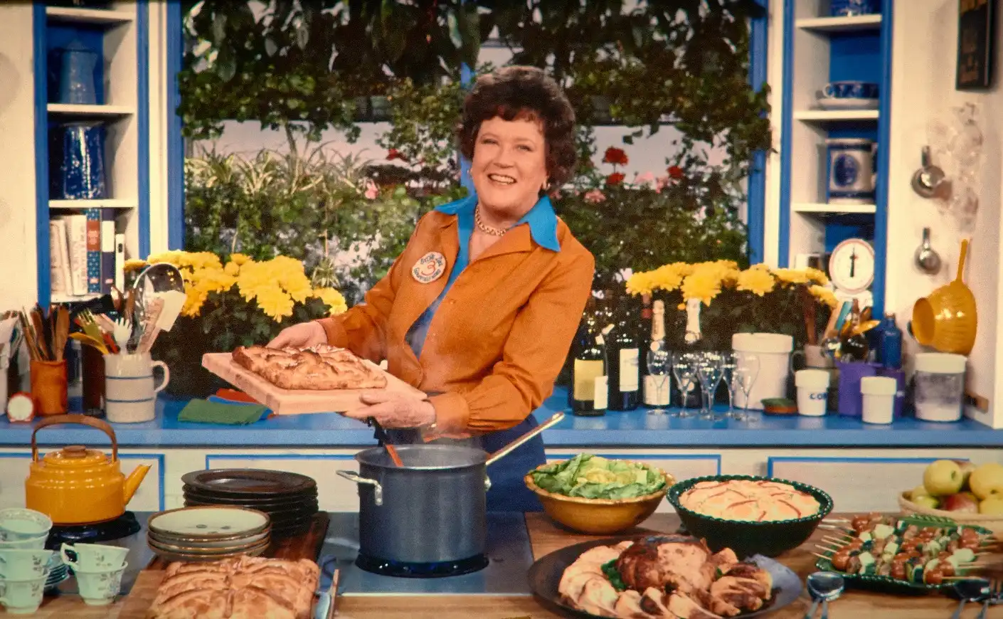 Julia Child in her kitchen cooking